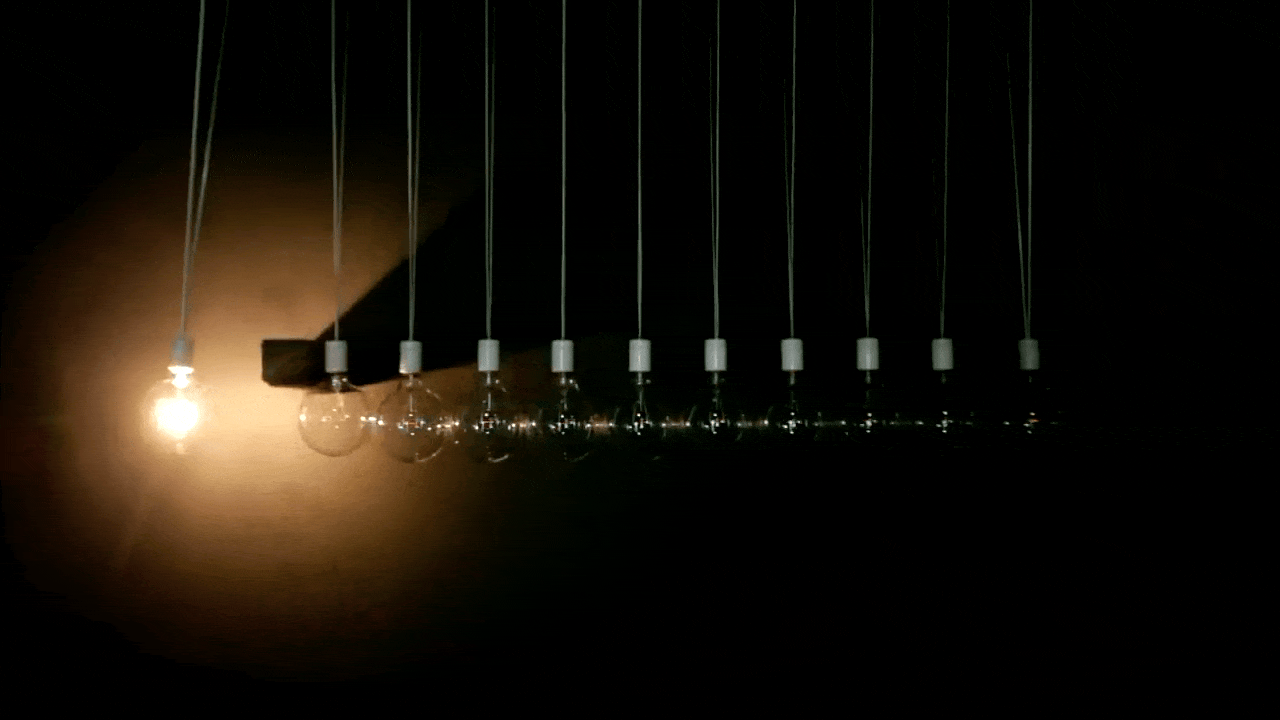 Animated loop of Asobi — light traveling from one suspended bulb to the next, mimicking the swing of a Newton's Cradle