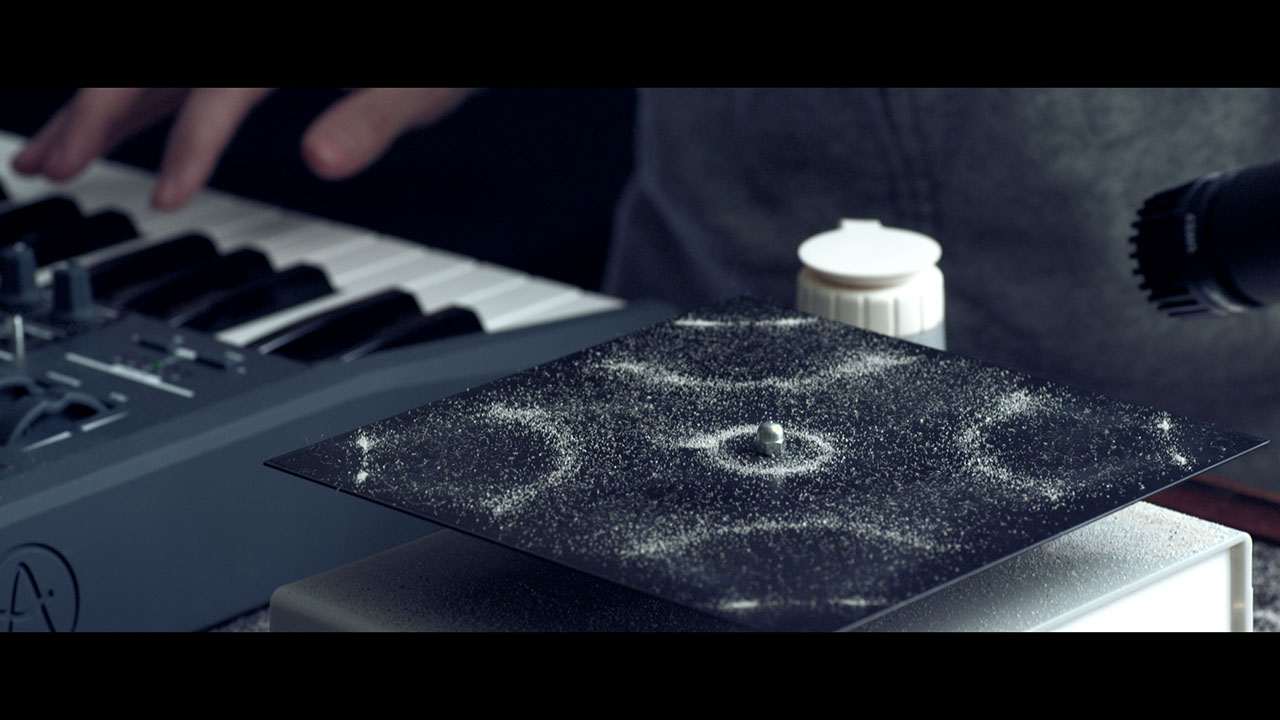 Ferrofluid spiking upward along magnetic field lines, forming black crowns