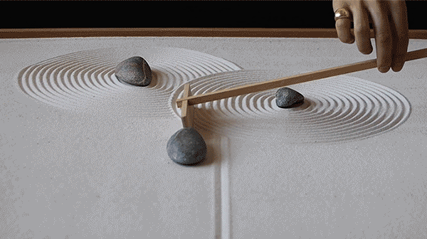 Yuki Kawae raking patterns into a zen sand garden